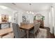 Bright formal dining area featuring neutral decor, wood table and an ornate chandelier at 11419 Emerald Shore Dr, Riverview, FL 33579