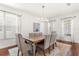 Formal dining room with wood floors, decorative rug, and modern chandelier at 11419 Emerald Shore Dr, Riverview, FL 33579