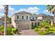 Beautiful two-story house showcasing a well-manicured lawn and a brick-paved driveway at 11419 Emerald Shore Dr, Riverview, FL 33579