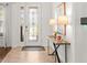 Elegant foyer with decorative glass front door, console table, and tile flooring at 11419 Emerald Shore Dr, Riverview, FL 33579