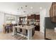 Modern kitchen featuring granite countertops, stainless steel appliances, and a large island with seating at 11419 Emerald Shore Dr, Riverview, FL 33579