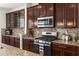 Close-up of modern kitchen featuring stainless steel appliances, granite countertops and tile backsplash at 11419 Emerald Shore Dr, Riverview, FL 33579