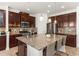 Granite countertop island with bar stool seating and stainless steel appliances in open modern kitchen at 11419 Emerald Shore Dr, Riverview, FL 33579