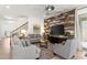 Bright and airy living room featuring a decorative wood-paneled wall and neutral furnishings at 11419 Emerald Shore Dr, Riverview, FL 33579