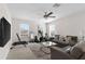 Cozy living room featuring neutral colored walls, grey sofas, a ceiling fan, and natural light at 11419 Emerald Shore Dr, Riverview, FL 33579