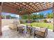 Inviting outdoor kitchen and patio area with a grill, bar, comfortable seating and a pergola at 11419 Emerald Shore Dr, Riverview, FL 33579