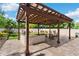 Inviting outdoor kitchen and patio area with a grill, stone detailing, comfortable seating and a pergola at 11419 Emerald Shore Dr, Riverview, FL 33579