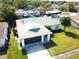 Aerial view of a well-maintained single-story home with a two-car garage and a neatly landscaped yard at 11520 Bear Paw Ln, Port Richey, FL 34668