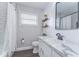 Bright, updated bathroom with a marble countertop, modern faucet, and a shower featuring a stylish patterned curtain at 11520 Bear Paw Ln, Port Richey, FL 34668