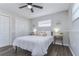 Inviting bedroom featuring a cozy queen bed, stylish side tables, a ceiling fan, and a spacious closet at 11520 Bear Paw Ln, Port Richey, FL 34668