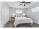 Inviting bedroom features a cozy queen bed, stylish side tables, a ceiling fan, and a spacious closet at 11520 Bear Paw Ln, Port Richey, FL 34668