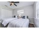 Comfortable bedroom featuring two twin beds, a ceiling fan, a window, and closet space, perfect for guests at 11520 Bear Paw Ln, Port Richey, FL 34668