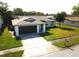 Well-maintained single-story home with a lush green lawn, a two-car garage, and a neatly landscaped front yard at 11520 Bear Paw Ln, Port Richey, FL 34668