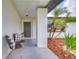 Cozy front porch with seating, a welcoming wreath, and stylish decor at 11520 Bear Paw Ln, Port Richey, FL 34668