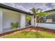 Inviting front entrance with well-maintained landscaping, mulch, and black accents at 11520 Bear Paw Ln, Port Richey, FL 34668