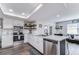 Charming kitchen with stainless steel appliances, stone counters, and open layout at 11520 Bear Paw Ln, Port Richey, FL 34668