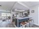 Stylish kitchen featuring island with seating, stainless steel fridge, and open floor plan at 11520 Bear Paw Ln, Port Richey, FL 34668