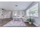 Open-concept living room with wood floors, a white sofa, and modern décor at 11520 Bear Paw Ln, Port Richey, FL 34668