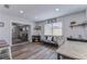 Bright living room featuring modern decor, wood flooring, and an open layout at 11520 Bear Paw Ln, Port Richey, FL 34668