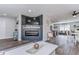 Inviting living room with modern fireplace, mounted TV, and open floor plan to kitchen at 11520 Bear Paw Ln, Port Richey, FL 34668