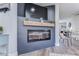 Cozy living room with a modern electric fireplace, sleek design, and hardwood floors at 11520 Bear Paw Ln, Port Richey, FL 34668