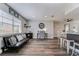 Open-concept living room with modern seating, wood floors, and abundant natural light at 11520 Bear Paw Ln, Port Richey, FL 34668