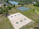 Aerial view of community tennis and basketball courts near a lake and neighborhood at 1213 Barmere Ln, Brandon, FL 33511