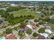 This is an aerial view of a neighborhood featuring a school, baseball fields, tennis courts, and a pond at 1213 Barmere Ln, Brandon, FL 33511