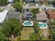 Aerial view of a home with a pool, patio, fenced yard, and solar panels on the roof at 1213 Barmere Ln, Brandon, FL 33511