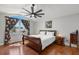 Comfortable bedroom featuring a vaulted ceiling, a ceiling fan, a window, and wood-look floors at 1213 Barmere Ln, Brandon, FL 33511