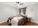 This is a bedroom featuring wood floors, a ceiling fan, closet, and matching floral comforter and window coverings at 1213 Barmere Ln, Brandon, FL 33511