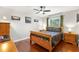 Cozy bedroom with hardwood floors, a ceiling fan, a window, and ample natural light at 1213 Barmere Ln, Brandon, FL 33511
