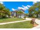 Charming two-story home featuring a well-manicured lawn and tropical landscaping, enhancing its curb appeal at 1213 Barmere Ln, Brandon, FL 33511