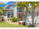 Inviting front entrance with a detailed front door, manicured landscaping, and a charming fountain at 1213 Barmere Ln, Brandon, FL 33511