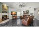 Cozy living room with a fireplace, leather furniture, and tile flooring at 1213 Barmere Ln, Brandon, FL 33511