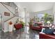 Bright living room with soaring ceilings, staircase, and elegant tile floors, showcasing a welcoming ambiance at 1213 Barmere Ln, Brandon, FL 33511