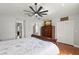 Serene primary bedroom with a ceiling fan, dresser, and closet, offering ample storage at 1213 Barmere Ln, Brandon, FL 33511