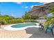 A private backyard oasis featuring a kidney-shaped pool, brick patio, and shaded seating area at 1213 Barmere Ln, Brandon, FL 33511
