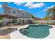 Backyard with a large swimming pool, patio, and a two story home at 1213 Barmere Ln, Brandon, FL 33511