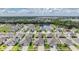 Aerial view of a residential community featuring a pond, lush greenery, and single Gathering homes at 12420 Brick Cobblestone Dr, Riverview, FL 33579