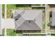 A top-down aerial view of the roof of a residential home with a gray shingle roof at 12420 Brick Cobblestone Dr, Riverview, FL 33579