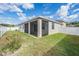 Exterior rear view shows screened patio, fenced backyard, and grass at 12420 Brick Cobblestone Dr, Riverview, FL 33579