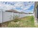 Long view of vinyl fenced backyard and exterior side of house at 12420 Brick Cobblestone Dr, Riverview, FL 33579