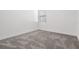 Empty bedroom shows neutral carpet, baseboards, and one window at 12420 Brick Cobblestone Dr, Riverview, FL 33579