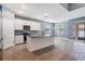This kitchen features stainless steel appliances, a stylish island, granite countertops, and a tile floor at 12420 Brick Cobblestone Dr, Riverview, FL 33579