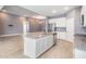 Open-concept kitchen features stainless steel appliances, an island with granite countertops, and ample cabinet space at 12420 Brick Cobblestone Dr, Riverview, FL 33579