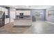 A kitchen featuring an island, stainless steel appliances, white cabinetry, and gray backsplash at 12420 Brick Cobblestone Dr, Riverview, FL 33579