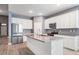 An island kitchen featuring stainless steel appliances and granite countertops offers both style and functionality at 12420 Brick Cobblestone Dr, Riverview, FL 33579