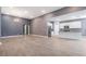 Open concept living room showcasing modern kitchen and neutral finishes, with an inviting atmosphere at 12420 Brick Cobblestone Dr, Riverview, FL 33579