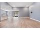 A spacious living room featuring wood-look tile floors, recessed lighting, and sliding glass doors at 12420 Brick Cobblestone Dr, Riverview, FL 33579